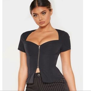 A black corset top from pretty little things